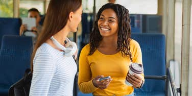 woman engaging in small talk with stranger on the bus