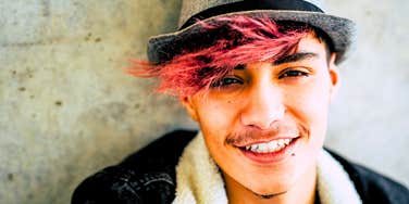 young man with pink hair who is different from everyone else