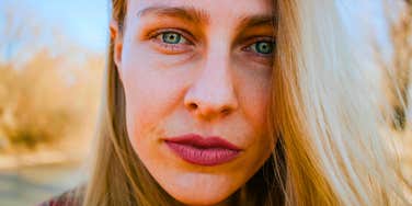 tough woman looking sad and uncertain up close