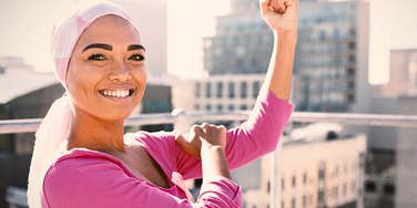 Brave young woman who isn't afraid of being strong flexing her muscles 