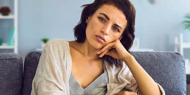 woman with low self-esteem looking upset at home
