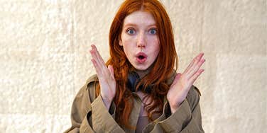 young redhead woman looking surprised because she has zero street smarts