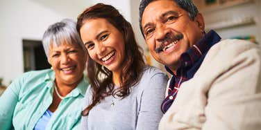 happy and smart woman smiling with her loving parents