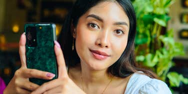 happy woman keeping her phone notifications off smiling