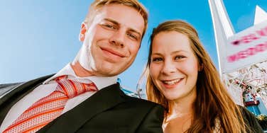 A close-up portrait of a newlywed couple getting married in an iconic Vegas wedding setting; illustrating 'the wedding budget paradox' and how high-expenditure milestones can correlate with long-term marital strain.