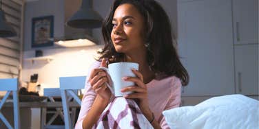 happy intelligent woman drinking tea following her grandpa's evening routine