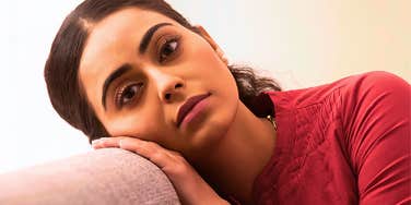 miserable woman laying at home complaining