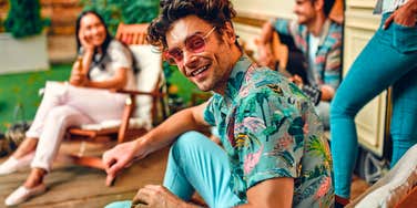 likable man in colorful clothing standing out at party