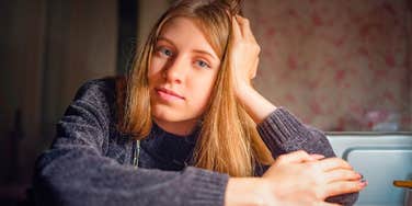 sad serious woman who grew up in tough financial times