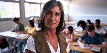serious older female teacher in classroom