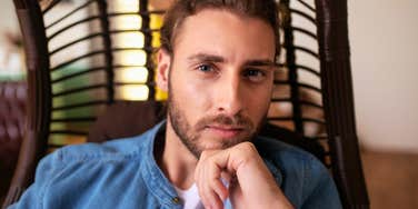 A handsome, thoughtful man looking intently ahead while making a decision; a visual representation of 'the deliberate thinker' and the subtle, casual behaviors deeply manipulative men exhibit.