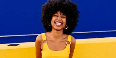 happy young vibrant woman standing outside