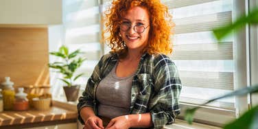 woman smiling at home in the sun as her life gets better