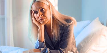 woman who hates her job sitting in bed worrying on sunday night