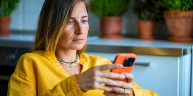 deep thinking woman looking at social media on her phone