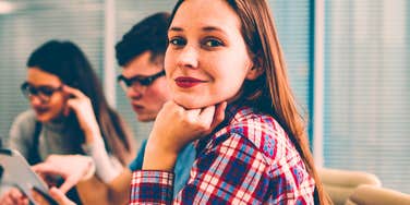 woman with a deep mind sitting with colleagues at work