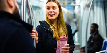 woman with a deep mind talking to a stranger on subway
