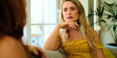 highly intelligent woman annoyed by friend during conversation