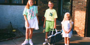 1990s siblings standing outside together