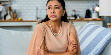 stressed woman sitting at home no longer taking care of herself