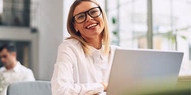 happy woman doing her annual tasks on a computer