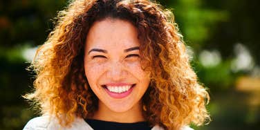 happy trustworthy woman smiling in the sun