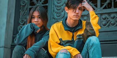 brother and sister siblings sitting next to each other looking serious