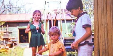 A vintage 1982 archival photo of children enjoying summer break outdoors, capturing uncurated play, generational nostalgia, and classic summer autonomy.