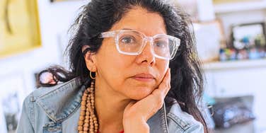 Adult woman looking resentful about her parents 