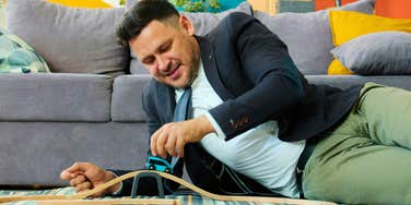 nostalgic intelligent man playing with toys that made him happy as a kid