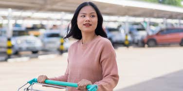 Woman in a grocery sopping cart making good money habits