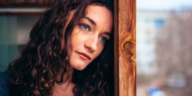 pensive emotionally and mentally lazy woman staring out the window