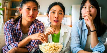 group of millennial women watching tv together