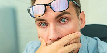 Millennials Are Having A Hard Time Making It Through A Full Day At Work For Legit Reasons millennial man feeling stressed at work looking tired