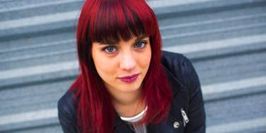 woman with a lone wolf personality standing outside alone