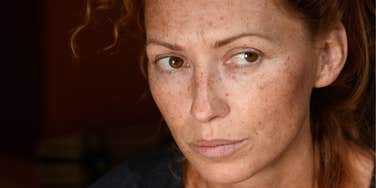 Oversensitive woman looks hurt and defensive at an innocent phrase 