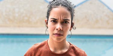Serious young woman whose parents taught her lessons that made her a stressed adult