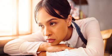 Sad Waiter in Paris Cafe, Woman Tired at Table in Bistro and Hospitality Service Industry Job. Disappointed Face in Small Business, Bored Fatigue at Restaurant and Mental Health Depression at Work