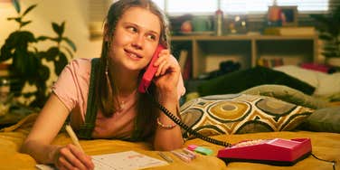 1990s teenager on the phone making friday night plans