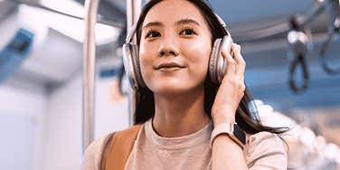 mentally and emotionally resilient woman smiling on a train 