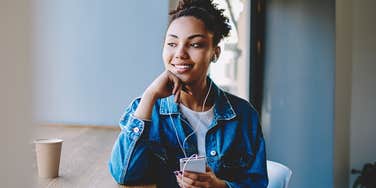 Peaceful woman enjoying her solitude wearing headphones 