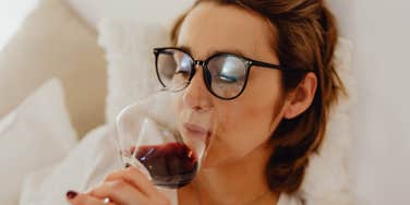 Woman can't relax without a glass of wine.