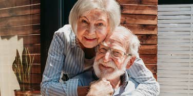 A loving senior couple enjoying a simple moment together in a kitchen, laughing as they prepare food, reflecting deep emotional connection and the joy of shared everyday life.