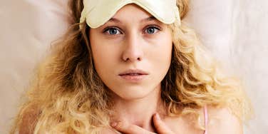 Young woman startled at night by a spooky feeling of a spirit 