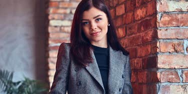Woman who lacks character smiling slyly 