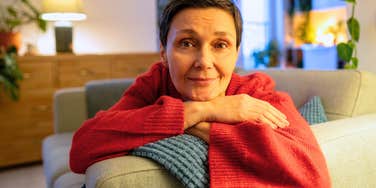 woman who likes spending time alone sitting on sofa