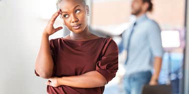 Woman with class considers how to tell a man at work to mind his business