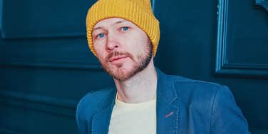 Man in a yellow hat trying to seem authentic but is actually a phony 