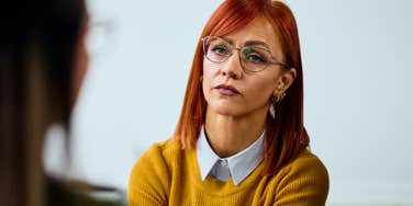 stern professional politely putting colleague in their place at work
