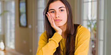 unbothered woman in conversation pretending to care